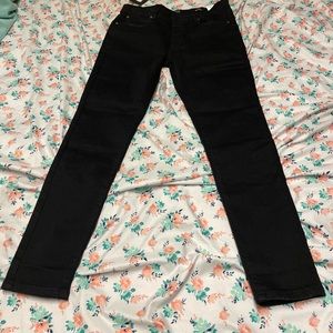 Black jeans with cool written on the back
